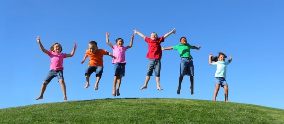 Group of multi-ethnic kids jumping together